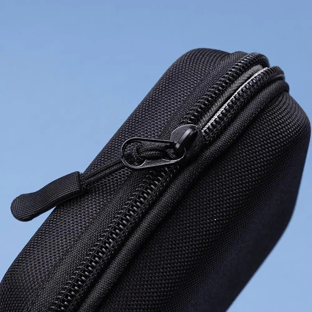 Black zippered pouch against a blue background