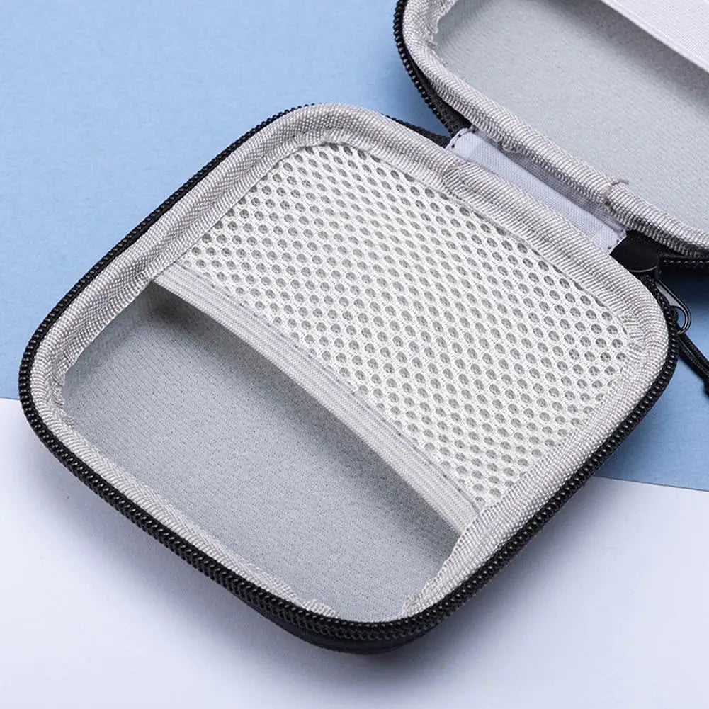 Gray hard-shell carrying case with mesh interior on a light blue and white background